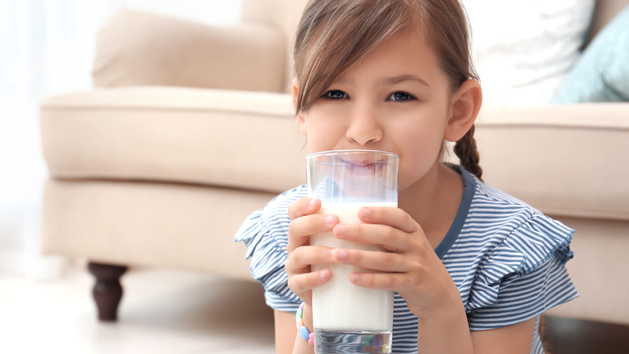 smiling-girl-enjoying-glass-of-milk-at-home-2026-03-27-02-12-14-utc_Crop Image (1)