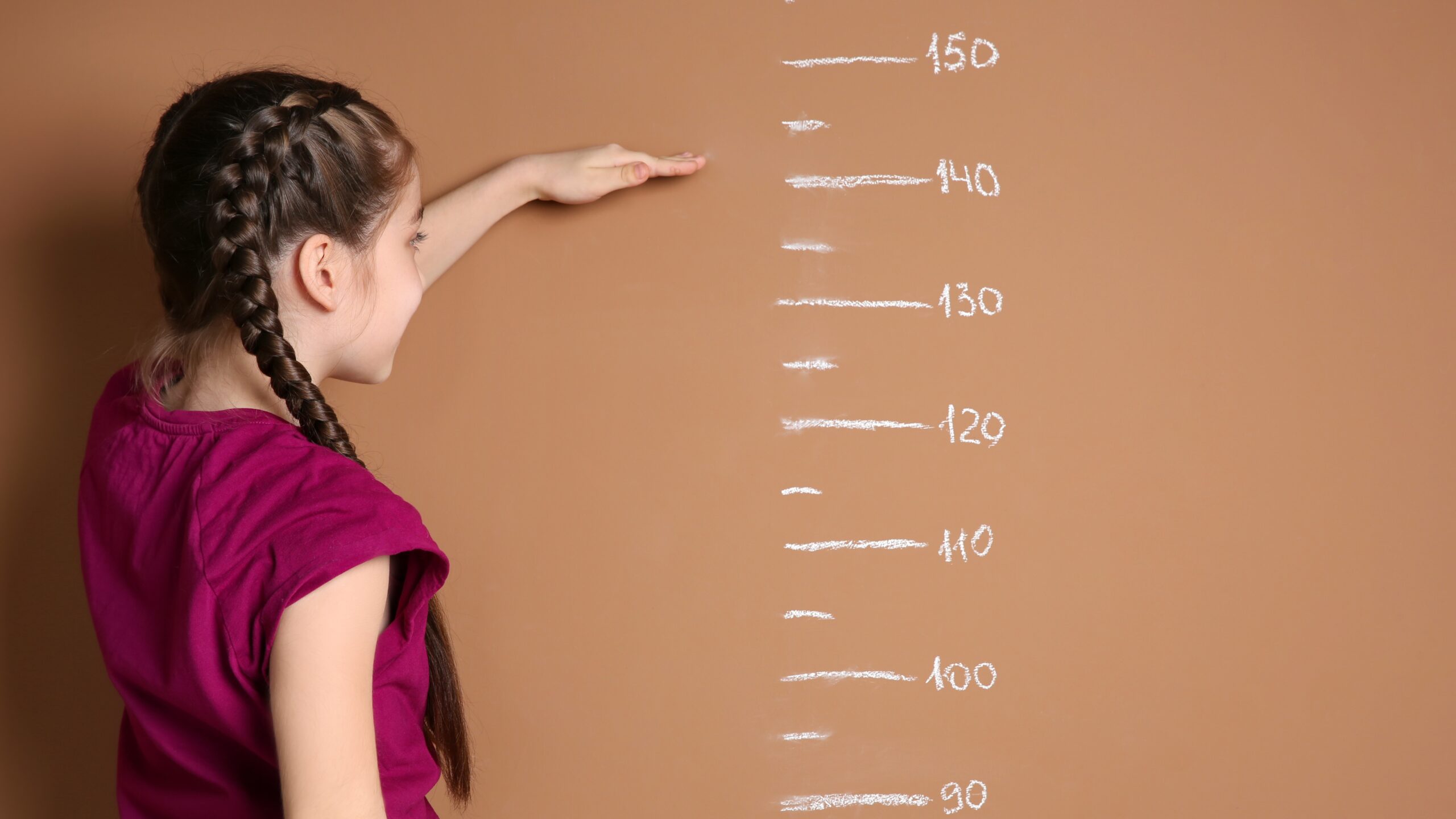 girl-measuring-her-height-at-home-2026-03-27-01-23-19-utc_Crop Image